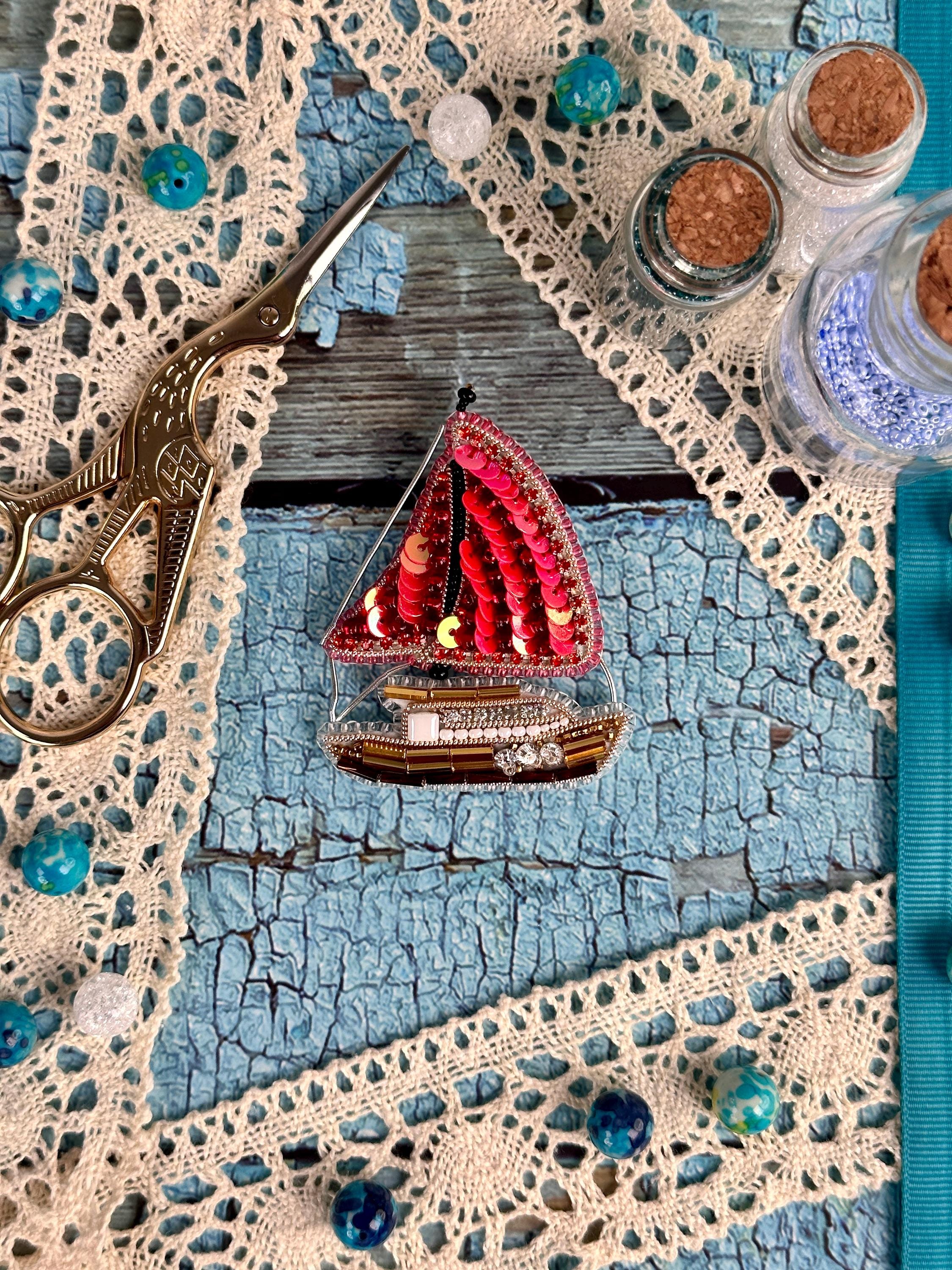 a pair of scissors sitting on top of a piece of cloth